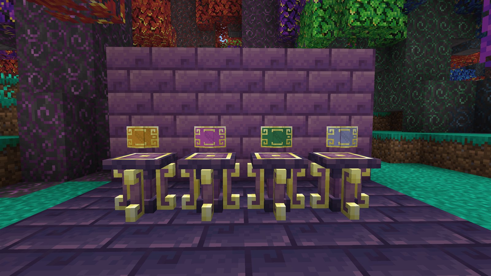 Four Ars Nouveau spell books dyed orange, pink, green, and blue, displayed on pedestals